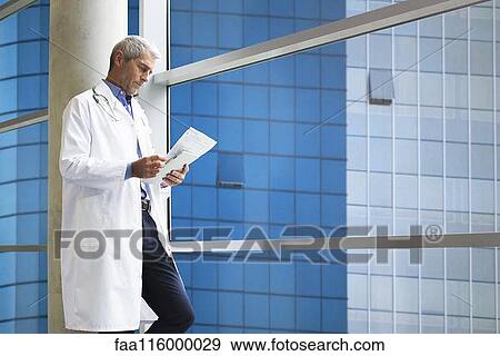 Doctor reading medical reports View Large Photo Image Stock Photo - Doctor reading medical reports. Fotosearch