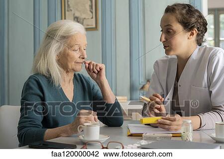 Doctor showing pill box to patient View Large Photo Image Stock Image - Doctor showing pill box to patient. Fotosearch