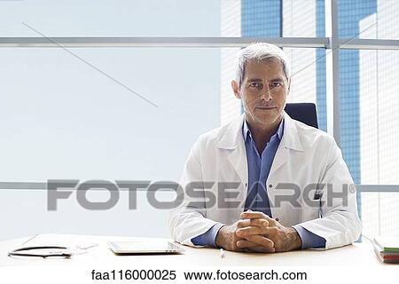 Doctor sitting in clinic View Large Photo Image Stock Photography - Doctor sitting in clinic. Fotosearch