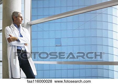 Doctor standing in clinic View Large Photo Image Stock Photo - Doctor standing in clinic. Fotosearch