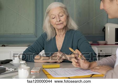 Doctor taking medical history of patient View Large Photo Image Picture - Doctor taking medical history of patient. Fotosearch
