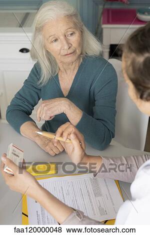 Doctor talking with patient View Large Photo Image Stock Photo - Doctor talking with patient. Fotosearch