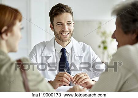 Stock Image - Doctor talking with senior patient. Fotosearch