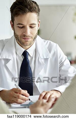 Doctor writing prescription in clinic View Large Photo Image Picture - Doctor writing prescription in clinic. Fotosearch