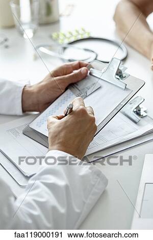 Doctor writing prescription on clipboard View Large Photo Image Stock Image - Doctor writing prescription on clipboard. Fotosearch
