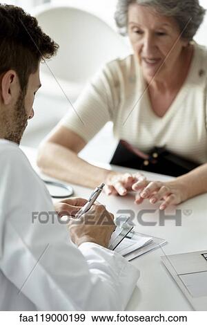 Doctor writing prescription View Large Photo Image Stock Photo - Doctor writing prescription. Fotosearch