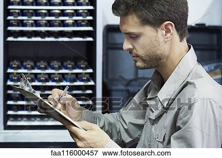 Engineer checking document in office View Large Photo Image Stock Photo - Engineer checking document in office. Fotosearch