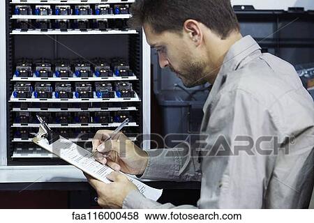 Engineer filling document in office View Large Photo Image Stock Photo - Engineer filling document in office. Fotosearch