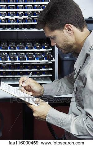 Engineer filling document in office View Large Photo Image Stock Photo - Engineer filling document in office. Fotosearch