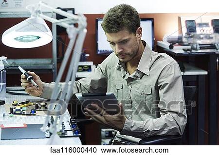 Engineer soldering circuit board in office View Large Photo Image Stock Image - Engineer soldering circuit board in office. Fotosearch