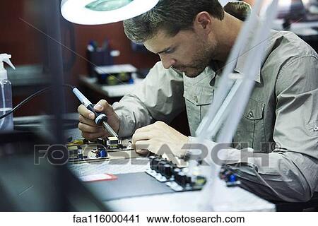 Engineer soldering circuit board in office View Large Photo Image Stock Image - Engineer soldering circuit board in office. Fotosearch
