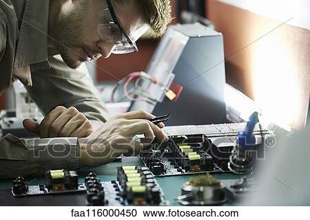 Engineer soldering circuit board in office View Large Photo Image Stock Image - Engineer soldering circuit board in office. Fotosearch