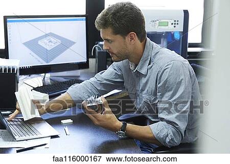 Stock Photo - Engineer using laptop in office. Fotosearch