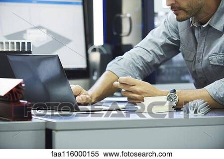 Engineer using laptop in office View Large Photo Image Stock Photography - Engineer using laptop in office. Fotosearch