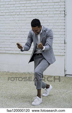 Excited man standing outdoors View Large Photo Image Stock Image - Excited man standing outdoors. Fotosearch