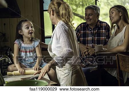 Stock Photo - Family talking in kitchen. Fotosearch