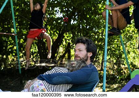 Father and daughter sitting in park View Large Photo Image Stock Photography - Father and daughter sitting in park. Fotosearch