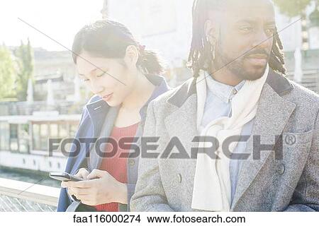 Picture - Friends standing together in boat. Fotosearch