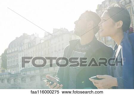 Stock Photography - Friends standing together in boat. Fotosearch