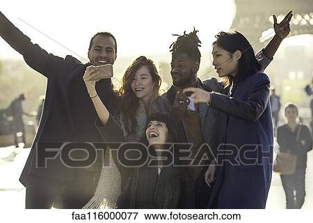 Friends taking selfie with smart phone View Large Photo Image Stock Photo - Friends taking selfie with smart phone. Fotosearch