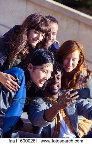 Friends taking selfie with smartphone View Large Photo Image Stock Image - Friends taking selfie with smartphone. Fotosearch
