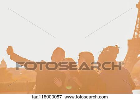 Friends taking selfie with smartphone View Large Photo Image Stock Photo - Friends taking selfie with smartphone. Fotosearch
