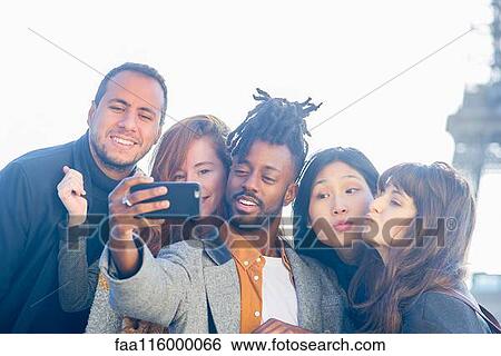Friends taking selfie with smartphone View Large Photo Image Stock Photograph - Friends taking selfie with smartphone. Fotosearch
