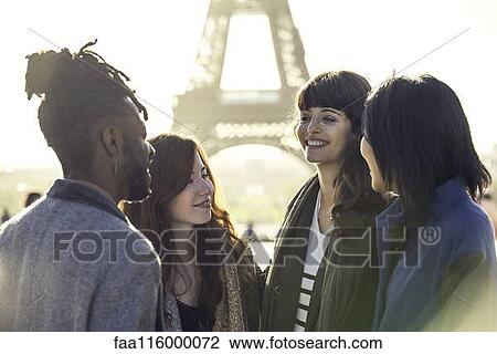 Friends talking together at Eiffel Tower View Large Photo Image Stock Image - Friends talking together at Eiffel Tower. Fotosearch
