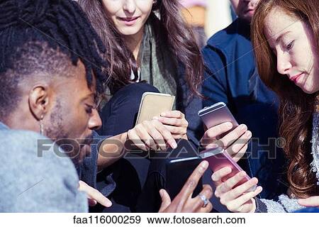 Friends using smartphone View Large Photo Image Stock Photo - Friends using smartphone. Fotosearch