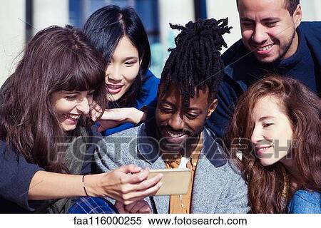 Friends using smartphone View Large Photo Image Stock Photography - Friends using smartphone. Fotosearch