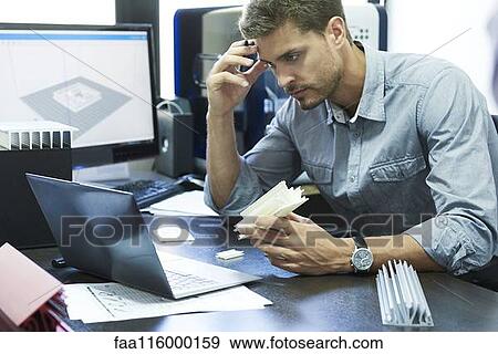 Stock Photo - Frustrated engineer working in office. Fotosearch