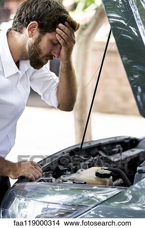 Frustrated man standing by car View Large Photo Image Picture - Frustrated man standing by car. Fotosearch