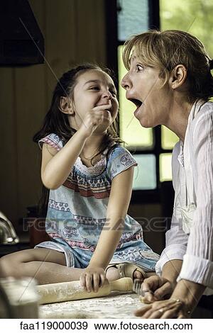 Granddaughter and grandmother preparing food View Large Photo Image Stock Photo - Granddaughter and grandmother preparing food. Fotosearch
