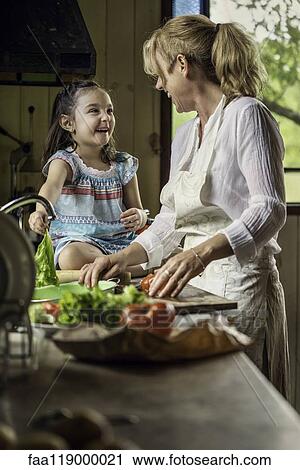 Grandmother and granddaughter preparing food View Large Photo Image Stock Image - Grandmother and granddaughter preparing food. Fotosearch