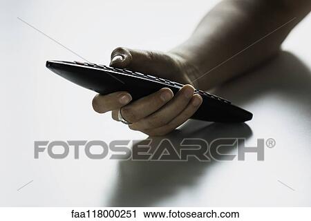 Hand holding remote control View Large Photo Image Stock Image - Hand holding remote control. Fotosearch