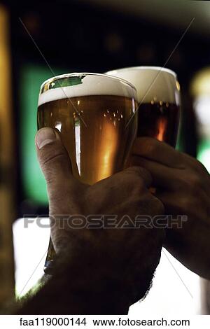 Hands toasting beer glasses View Large Photo Image Picture - Hands toasting beer glasses. Fotosearch
