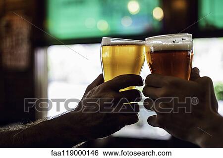 Hands toasting beer glasses View Large Photo Image Stock Photograph - Hands toasting beer glasses. Fotosearch