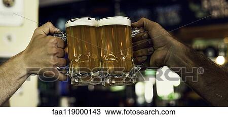 Hands toasting beer mugs View Large Photo Image Stock Image - Hands toasting beer mugs. Fotosearch