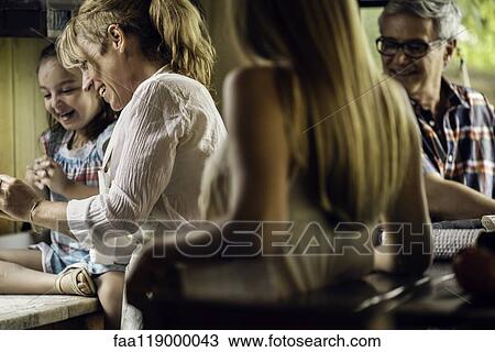Stock Image - Happy family in kitchen. Fotosearch