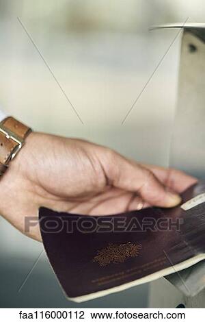 Human hand inserting passport in machine View Large Photo Image Stock Image - Human hand inserting passport in machine. Fotosearch