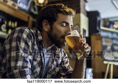 Man drinking beer View Large Photo Image Stock Photo - Man drinking beer. Fotosearch