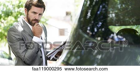 Man examining car View Large Photo Image Stock Photography - Man examining car. Fotosearch