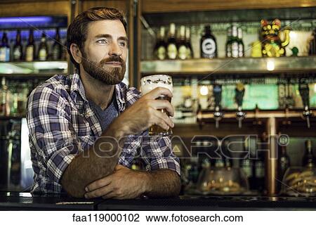 Man holding beer glass View Large Photo Image Stock Image - Man holding beer glass. Fotosearch