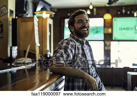 Man leaning against bar counter View Large Photo Image Stock Photo - Man leaning against bar counter. Fotosearch