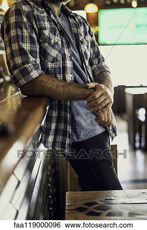 Man leaning against bar counter View Large Photo Image Stock Photograph - Man leaning against bar counter. Fotosearch
