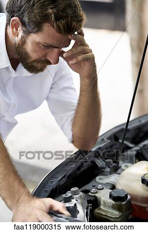 Man looking at car engine View Large Photo Image Stock Photography - Man looking at car engine. Fotosearch