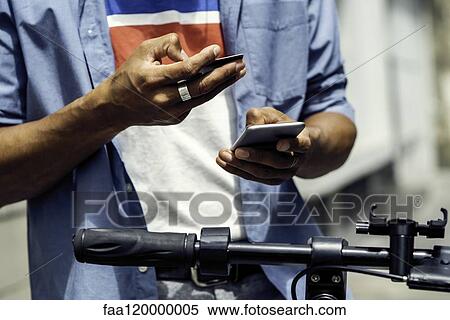 Stock Photography - Man making online payment with credit card. Fotosearch
