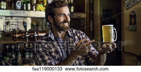 Man pointing at beer mug View Large Photo Image Stock Image - Man pointing at beer mug. Fotosearch