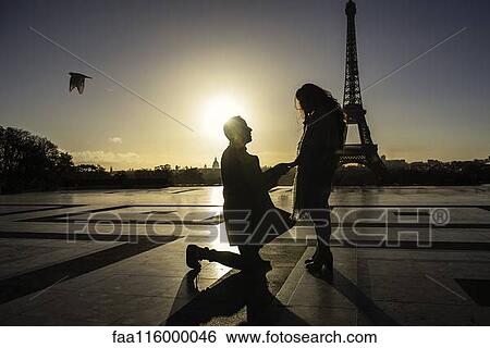 Man proposing to woman near Eiffel Tower View Large Photo Image Stock Photograph - Man proposing to woman near Eiffel Tower. Fotosearch