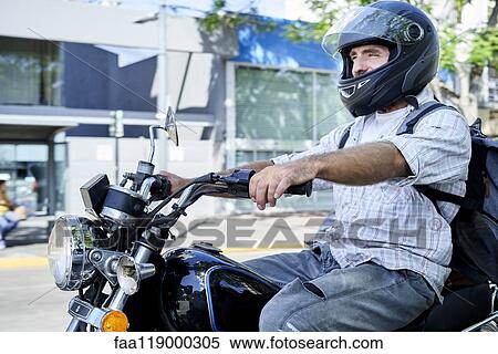 Stock Photography - Man riding motorbike. Fotosearch